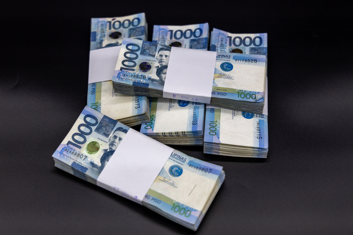 A pile of one thousand Philippines peso banknotes. Cash of Thousand dollar bills, Peso background image.